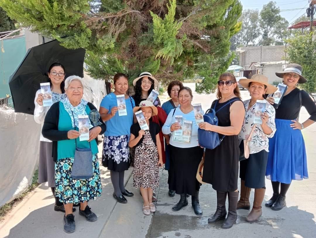 Members of a congregation sharing a welcoming community moment outdoors.